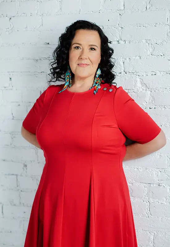 Kristine Dandavino red dress against the wall